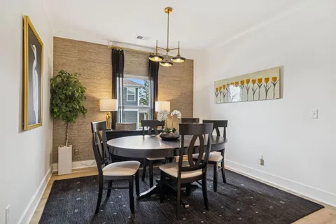 a dining room with furniture and window