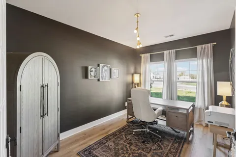 a living room with furniture mirror and a wooden floor