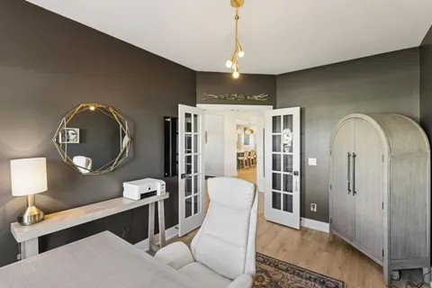 a bathroom with a granite countertop toilet sink and mirror