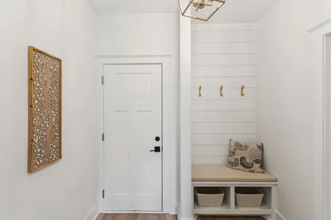 a bedroom with a bed and a refrigerator