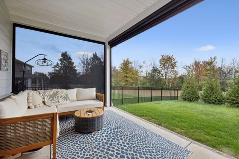 a view of a house with a backyard porch and sitting area