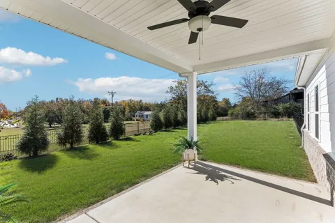 a front view of a house with a garden and yard