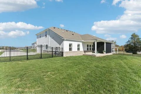 a view of a wooden house with a yard