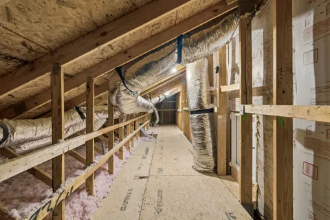 a city street with a building and couple of cars parked in front of it