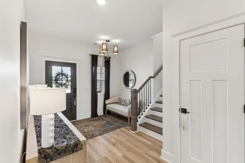 a view of a hallway with furniture and a livingroom