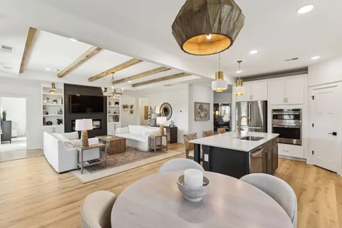 a living room with furniture kitchen view and a fireplace