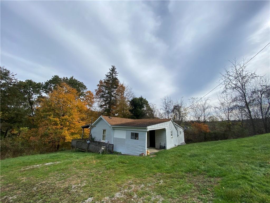 290 Calverts Hill Road Spraggs, PA 15362 - Photo 2 of 22 a front view of a house with a garden