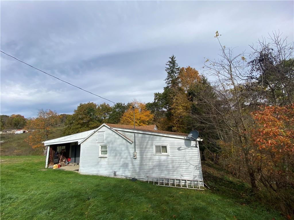 290 Calverts Hill Road Spraggs, PA 15362 - Photo 3 of 22 a front view of a house with garden
