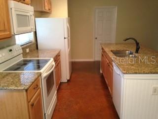 344 Beverly Road Venice, FL 34293 - Photo 2 of 14 a kitchen with granite countertop a sink and a stove