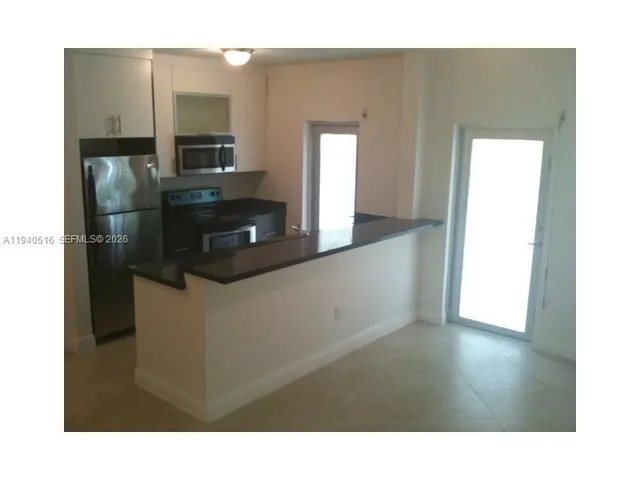 a kitchen with stainless steel appliances a refrigerator and a sink