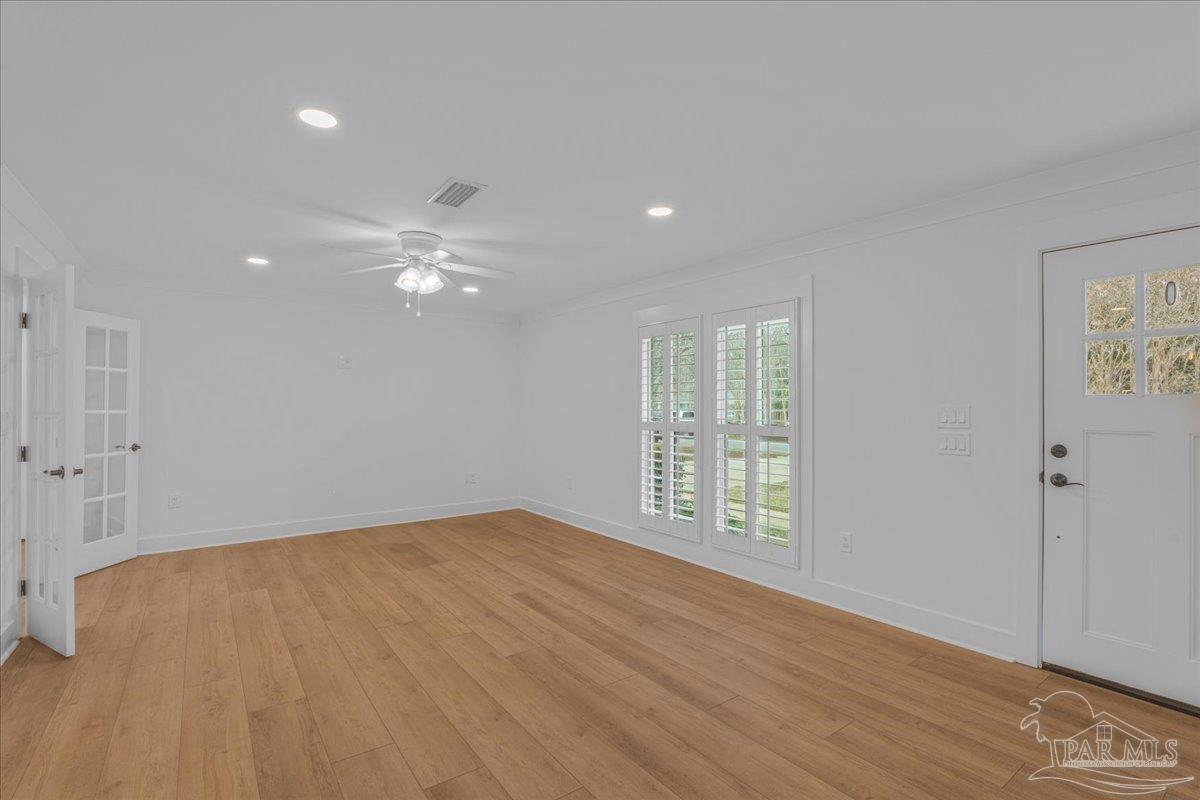 3540 Dunfries Road Pensacola, FL 32503 - Photo 11 of 48 a view of an empty room with wooden floor and a window