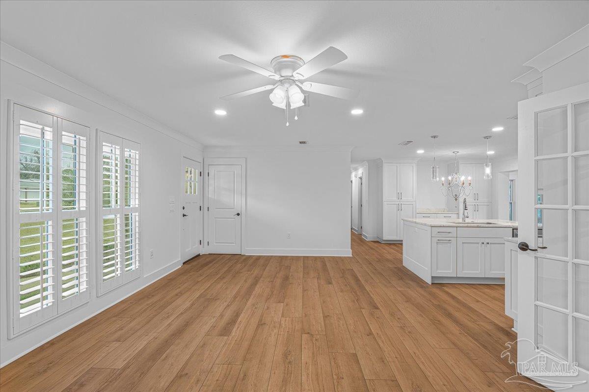 3540 Dunfries Road Pensacola, FL 32503 - Photo 13 of 48 a view of a kitchen with a sink and wooden floor