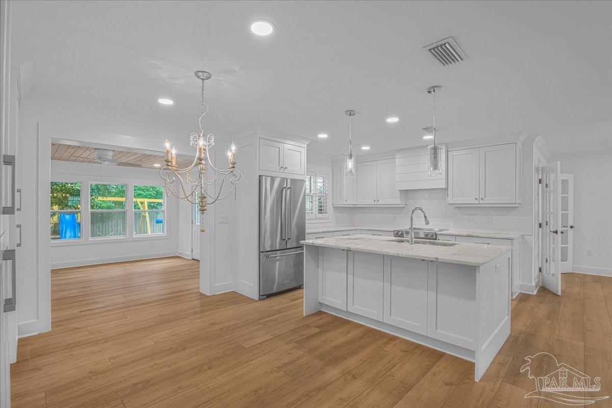 3540 Dunfries Road Pensacola, FL 32503 - Photo 14 of 48 a open kitchen with kitchen island a sink stainless steel appliances and cabinets