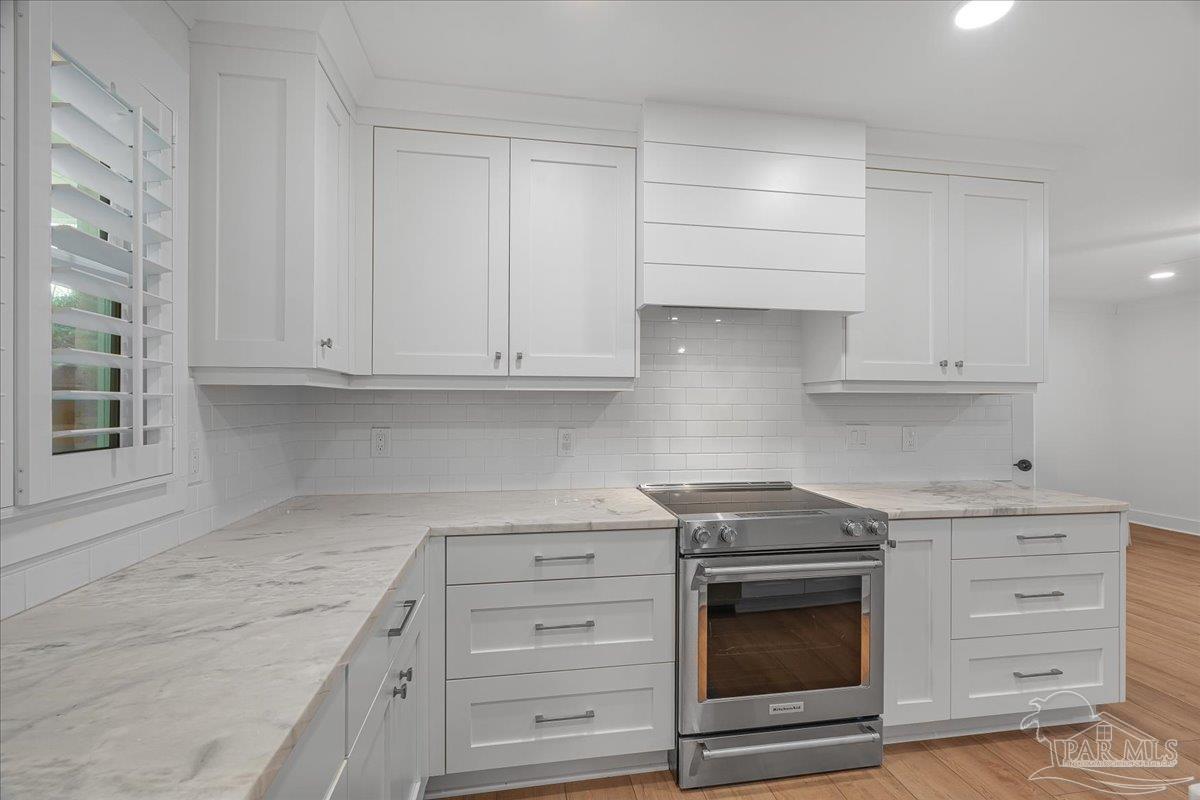3540 Dunfries Road Pensacola, FL 32503 - Photo 16 of 48 a kitchen with granite countertop white cabinets and stainless steel appliances