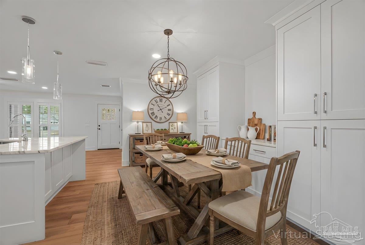 3540 Dunfries Road Pensacola, FL 32503 - Photo 20 of 48 a view of a dining room with furniture a chandelier and wooden floor