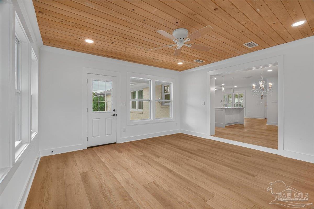 3540 Dunfries Road Pensacola, FL 32503 - Photo 23 of 48 a view of an empty room with wooden floor and a window