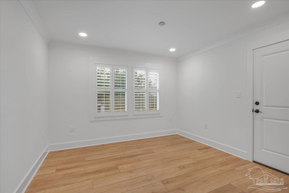 3540 Dunfries Road Pensacola, FL 32503 - Photo 24 of 48 a view of an empty room with wooden floor and a window