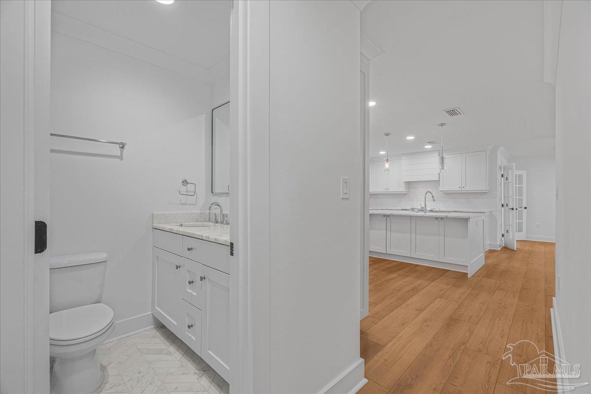 3540 Dunfries Road Pensacola, FL 32503 - Photo 27 of 48 a view of bathroom with a toilet sink and a mirror