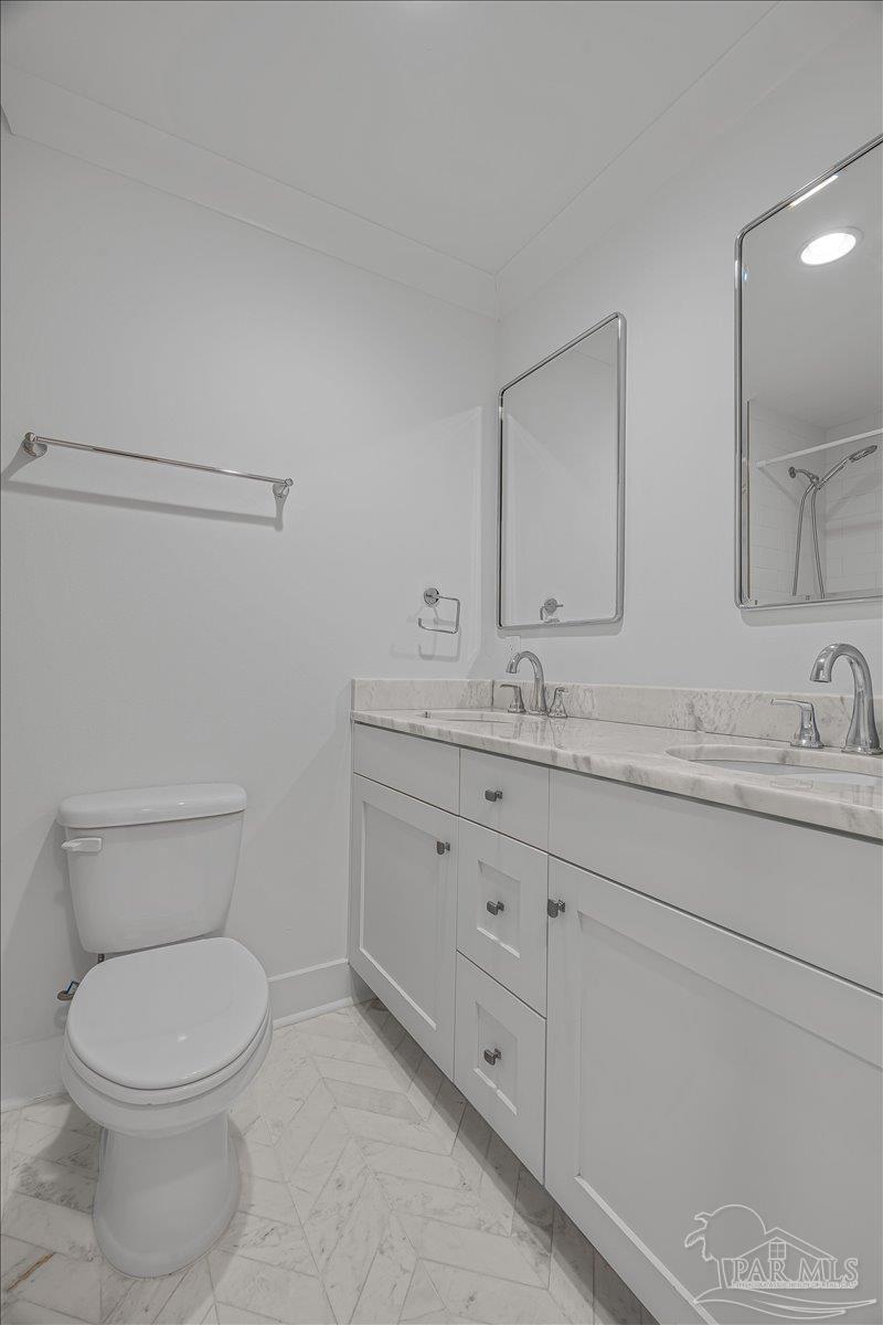 3540 Dunfries Road Pensacola, FL 32503 - Photo 28 of 48 a bathroom with a granite countertop toilet sink and mirror