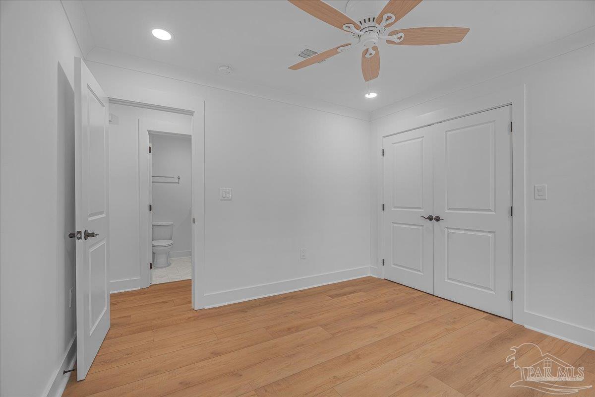 3540 Dunfries Road Pensacola, FL 32503 - Photo 32 of 48 wooden floor in an empty room with a fan