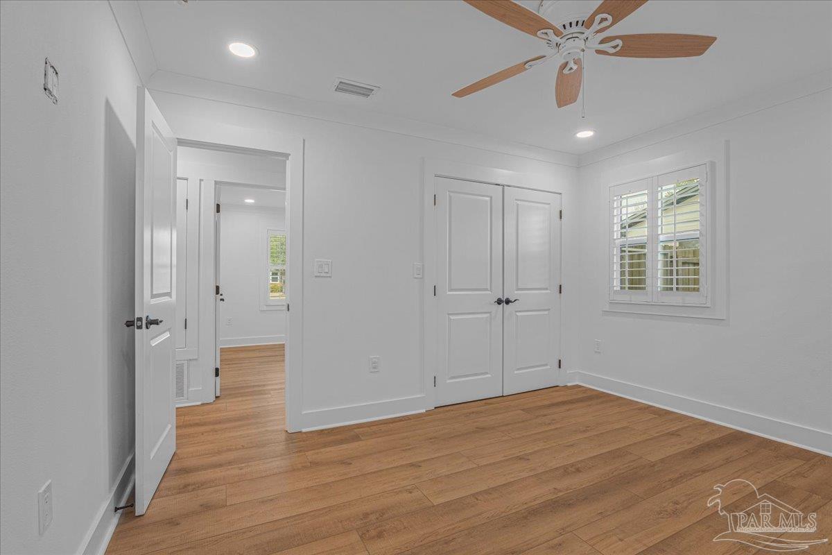 3540 Dunfries Road Pensacola, FL 32503 - Photo 35 of 48 wooden floor in an empty room with a window
