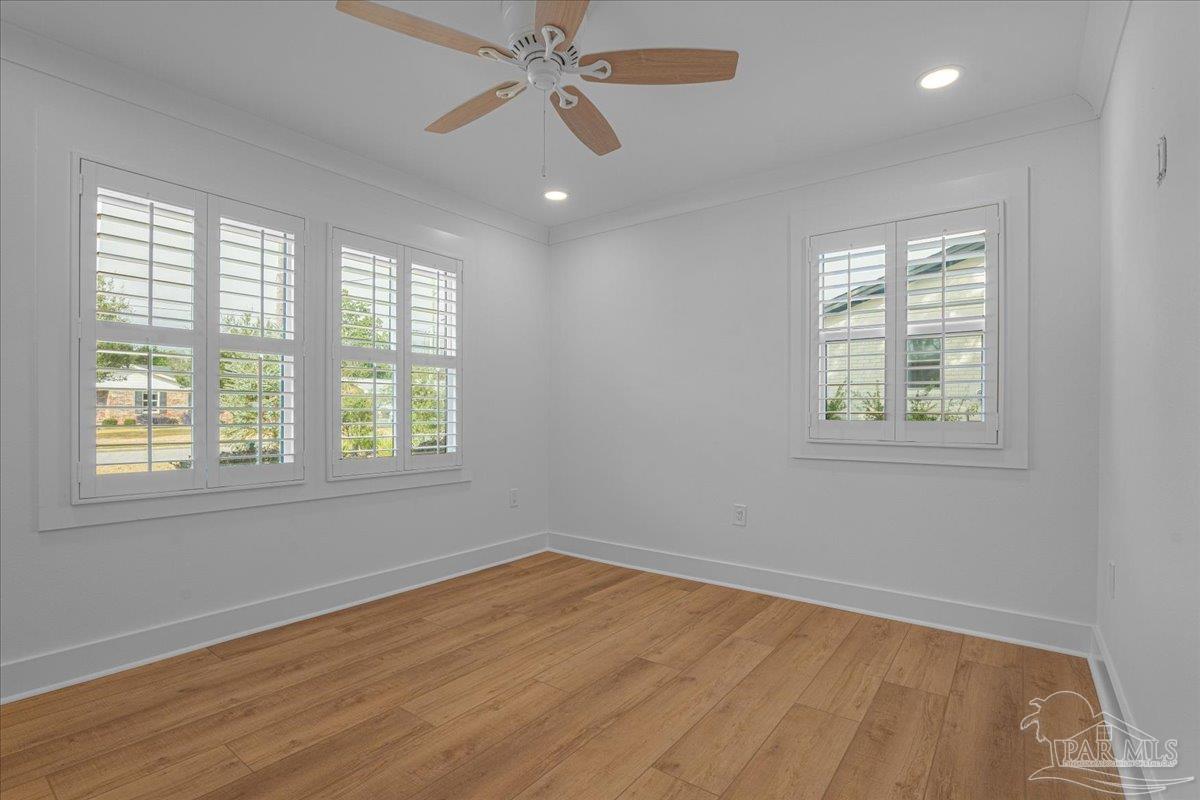 3540 Dunfries Road Pensacola, FL 32503 - Photo 38 of 48 a view of an empty room with wooden floor and a window