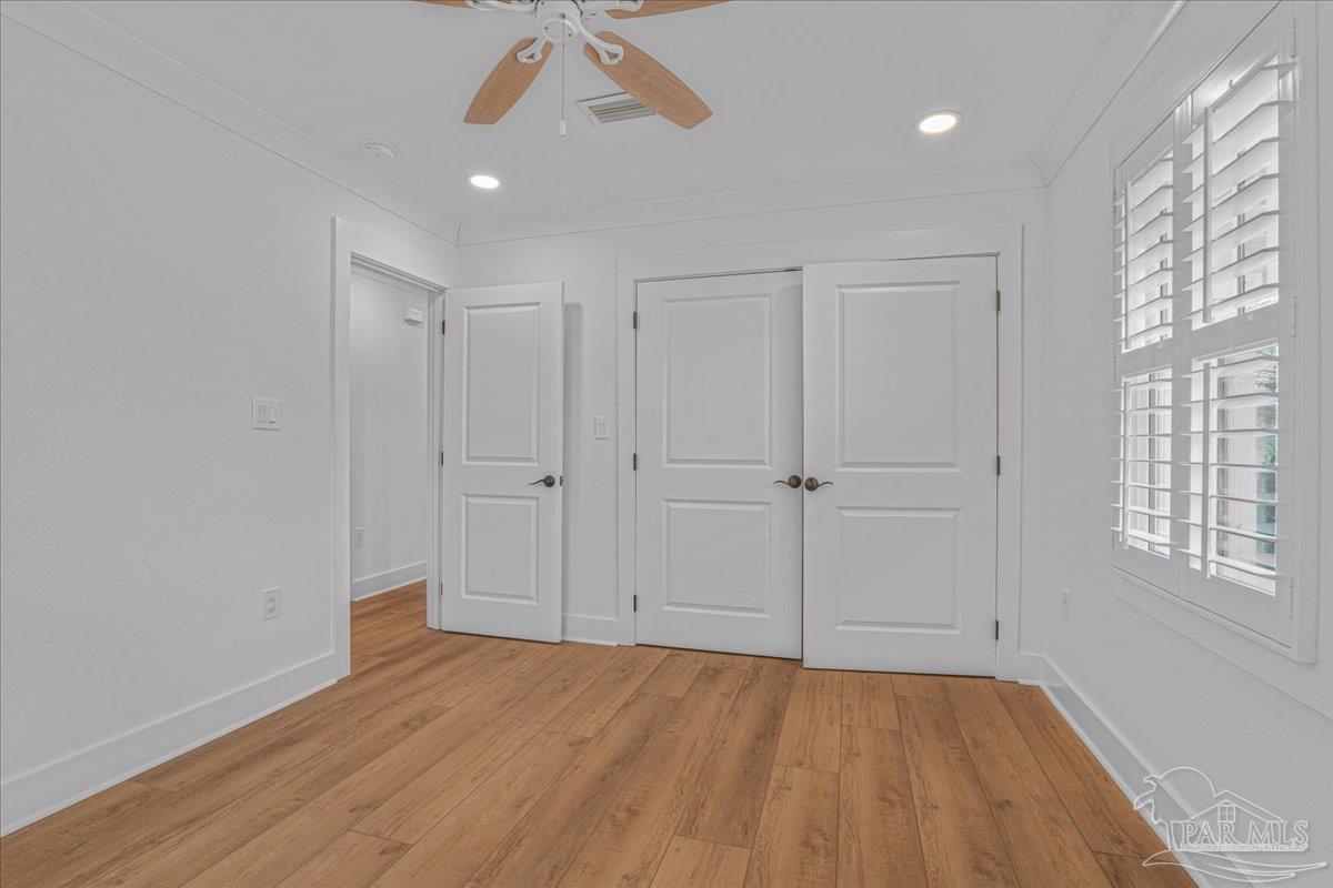 3540 Dunfries Road Pensacola, FL 32503 - Photo 40 of 48 wooden floor in an empty room with a window