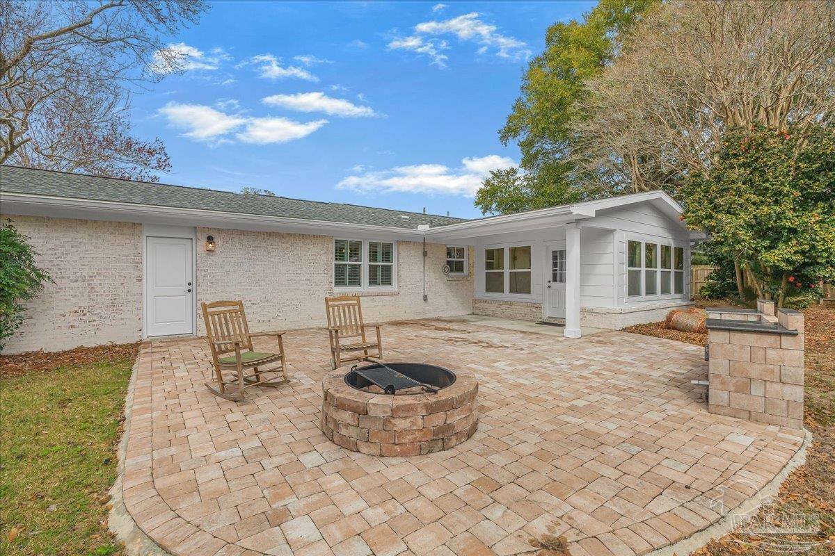 3540 Dunfries Road Pensacola, FL 32503 - Photo 42 of 48 a view of a house with backyard sitting area and tub