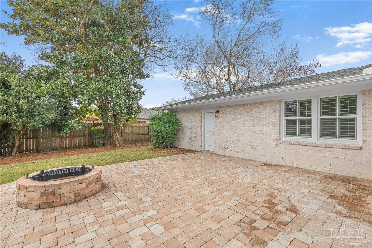 3540 Dunfries Road Pensacola, FL 32503 - Photo 43 of 48 a backyard of house with large trees and wooden fence
