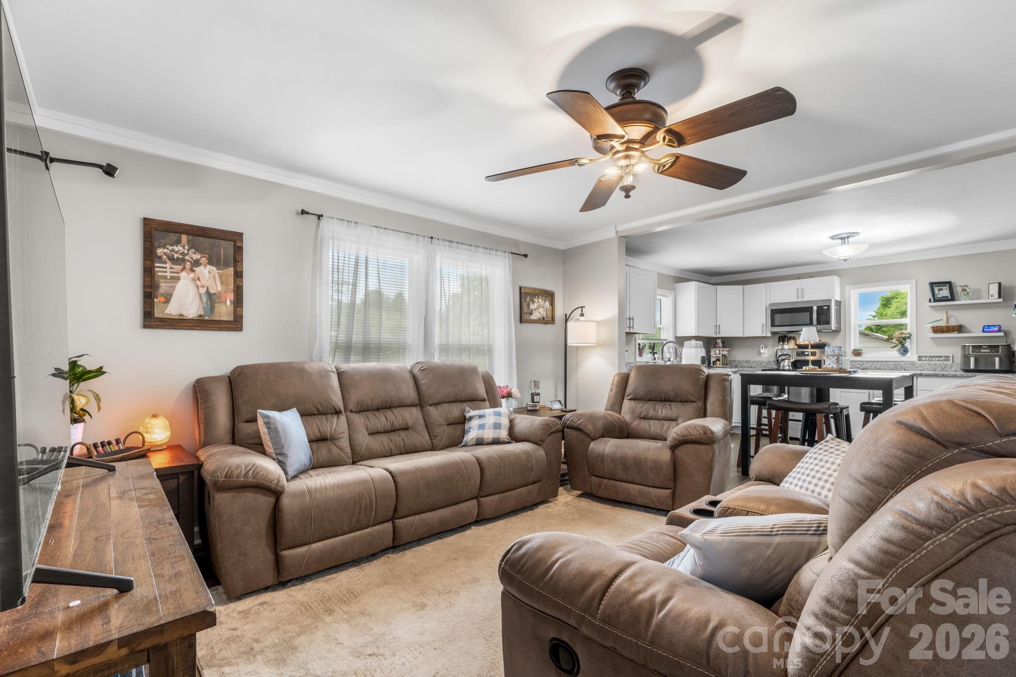 3941 Springs Road Northeast Conover, NC 28613 - Photo 6 of 21 a living room with furniture a ceiling fan and a window