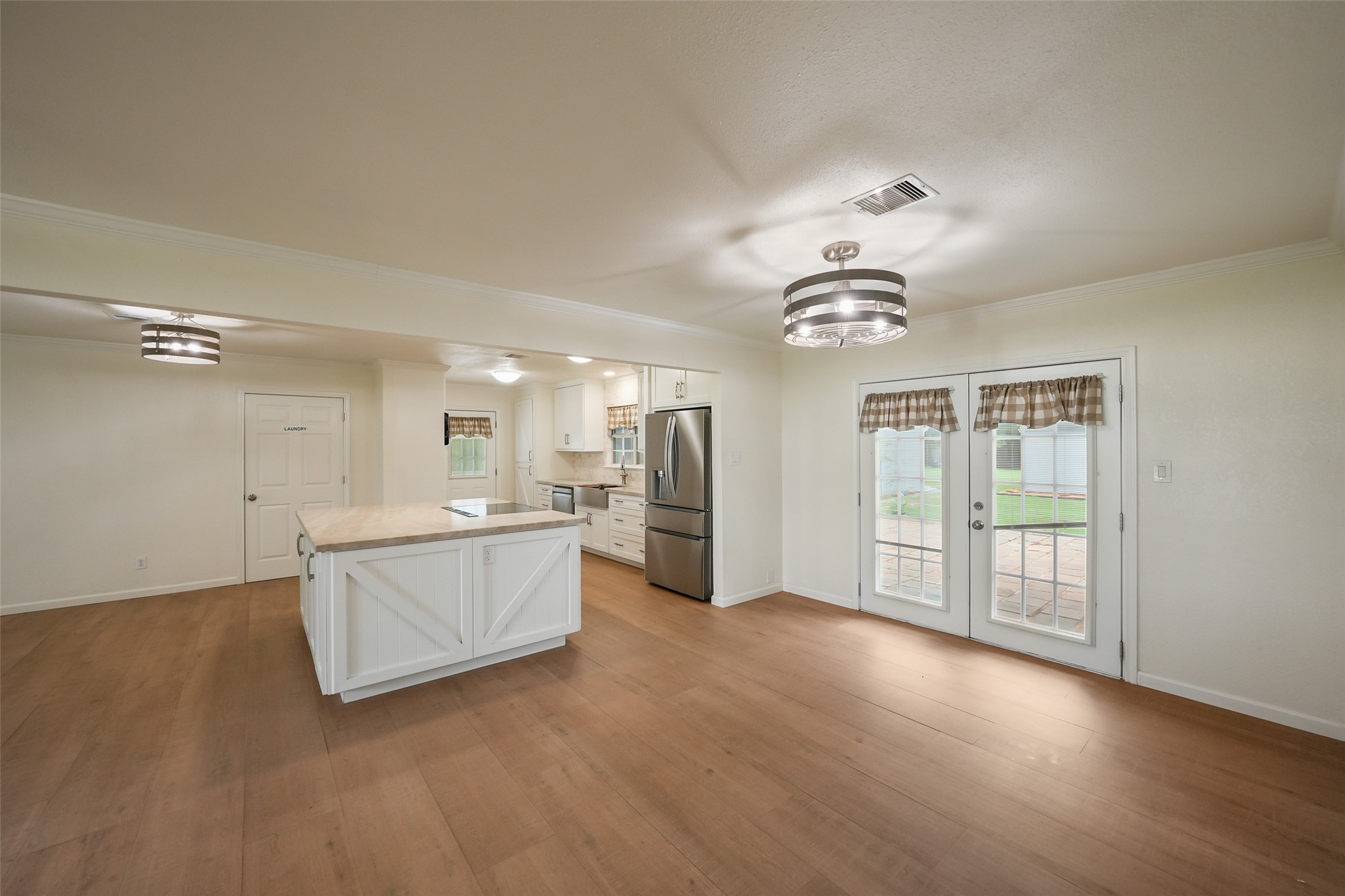 19635 Kermier Road Waller, TX 77484 - Photo 13 of 27 Expansive open-concept living space with views into the kitchen and dining area.