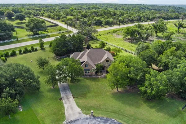an aerial view of a house with a yard
