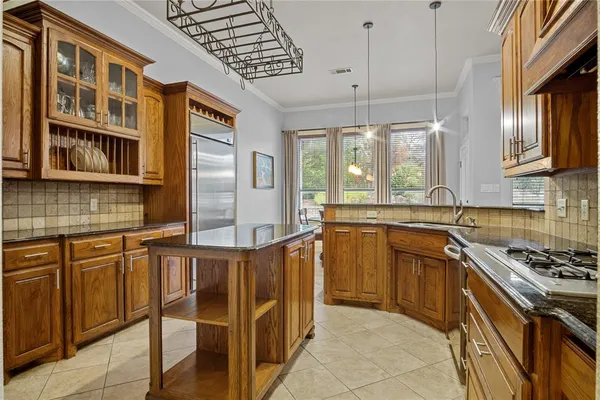 a kitchen with stainless steel appliances a stove sink and cabinets