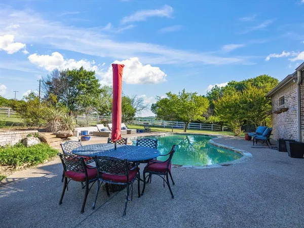 a backyard of a house with outdoor seating