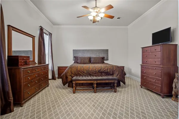 a bedroom with a bed and flat screen tv