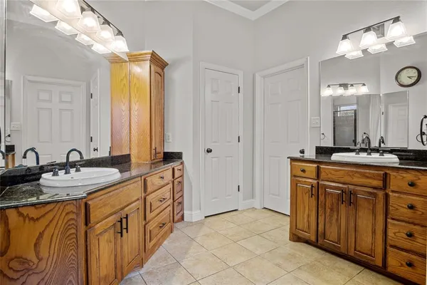 a spacious bathroom with a granite countertop sink mirror and double