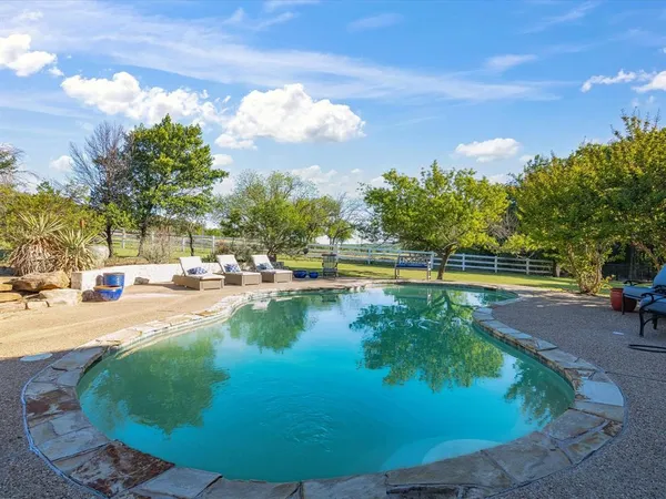 a view of a swimming pool with an outdoor seating
