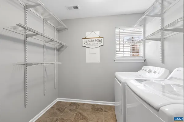 a utility room with closet and window