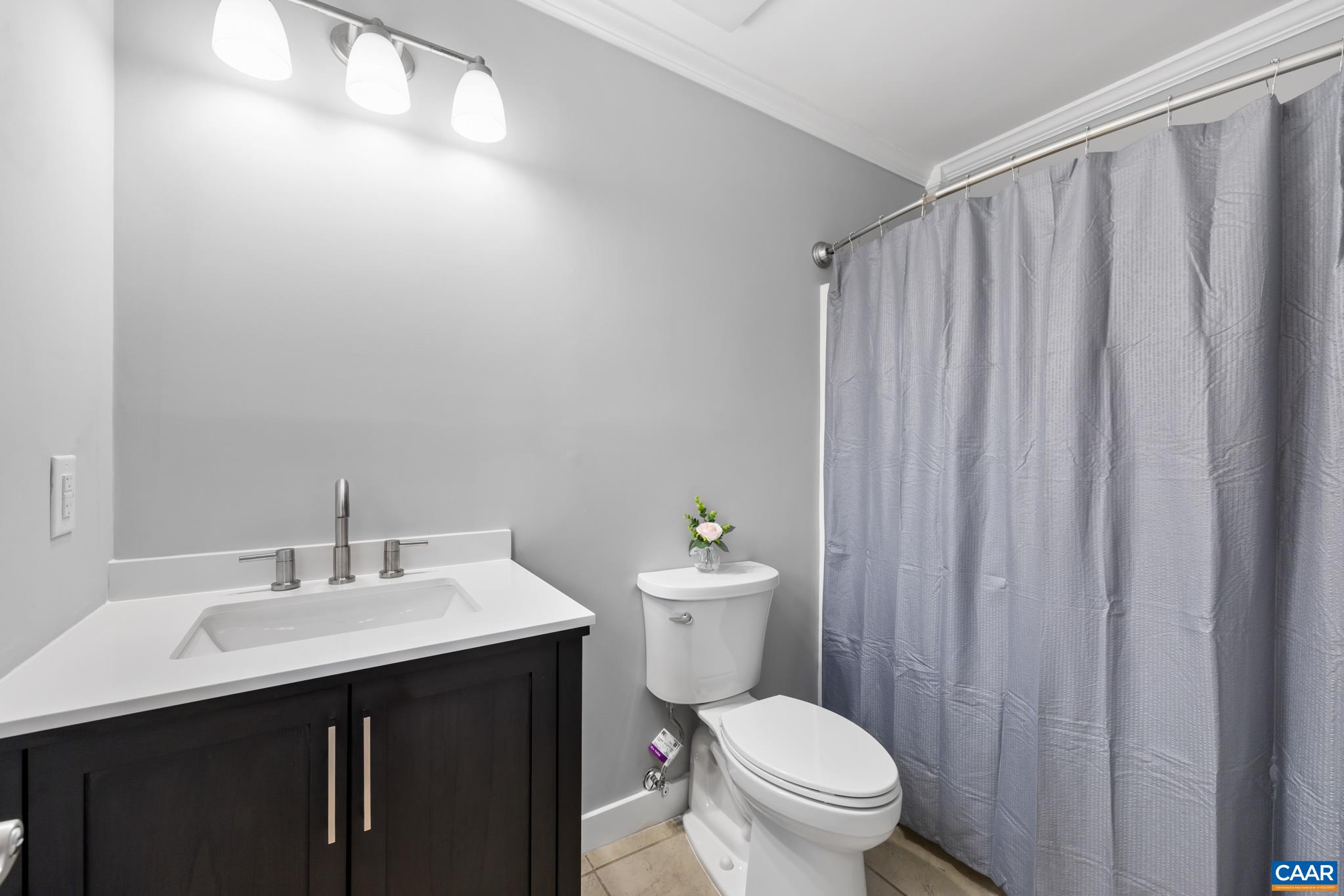 23 North Ridge Way Stanardsville, VA 22973 - Photo 12 of 19 a bathroom with a sink a toilet a mirror and shower curtain