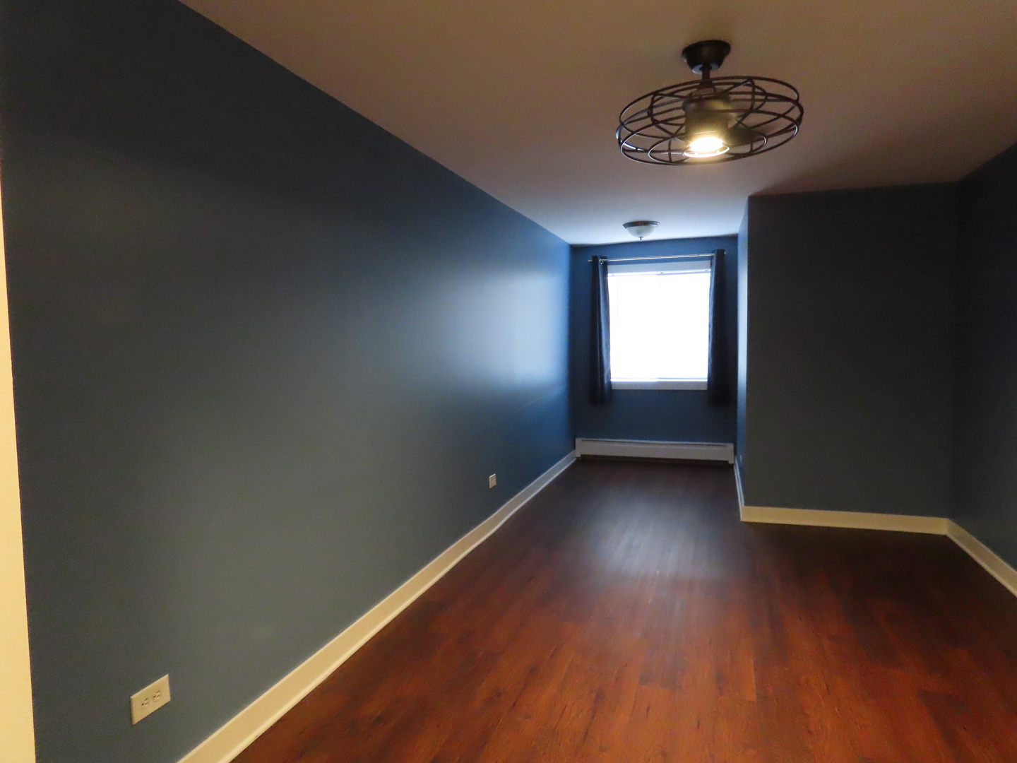 14830 Ketelaar Drive, Unit 4E Midlothian, IL 60445 - Photo 11 of 23 a view of an empty room with wooden floor and a window