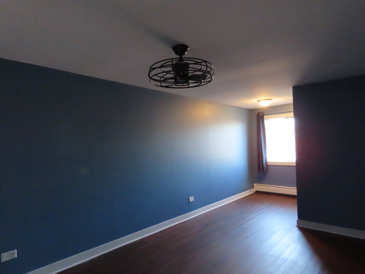 14830 Ketelaar Drive, Unit 4E Midlothian, IL 60445 - Photo 12 of 23 a view of an empty room with wooden floor and a window