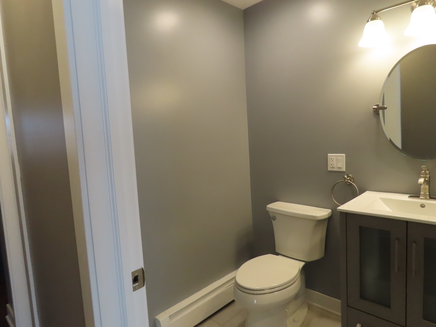 14830 Ketelaar Drive, Unit 4E Midlothian, IL 60445 - Photo 15 of 23 a white toilet sitting next to a bathroom sink