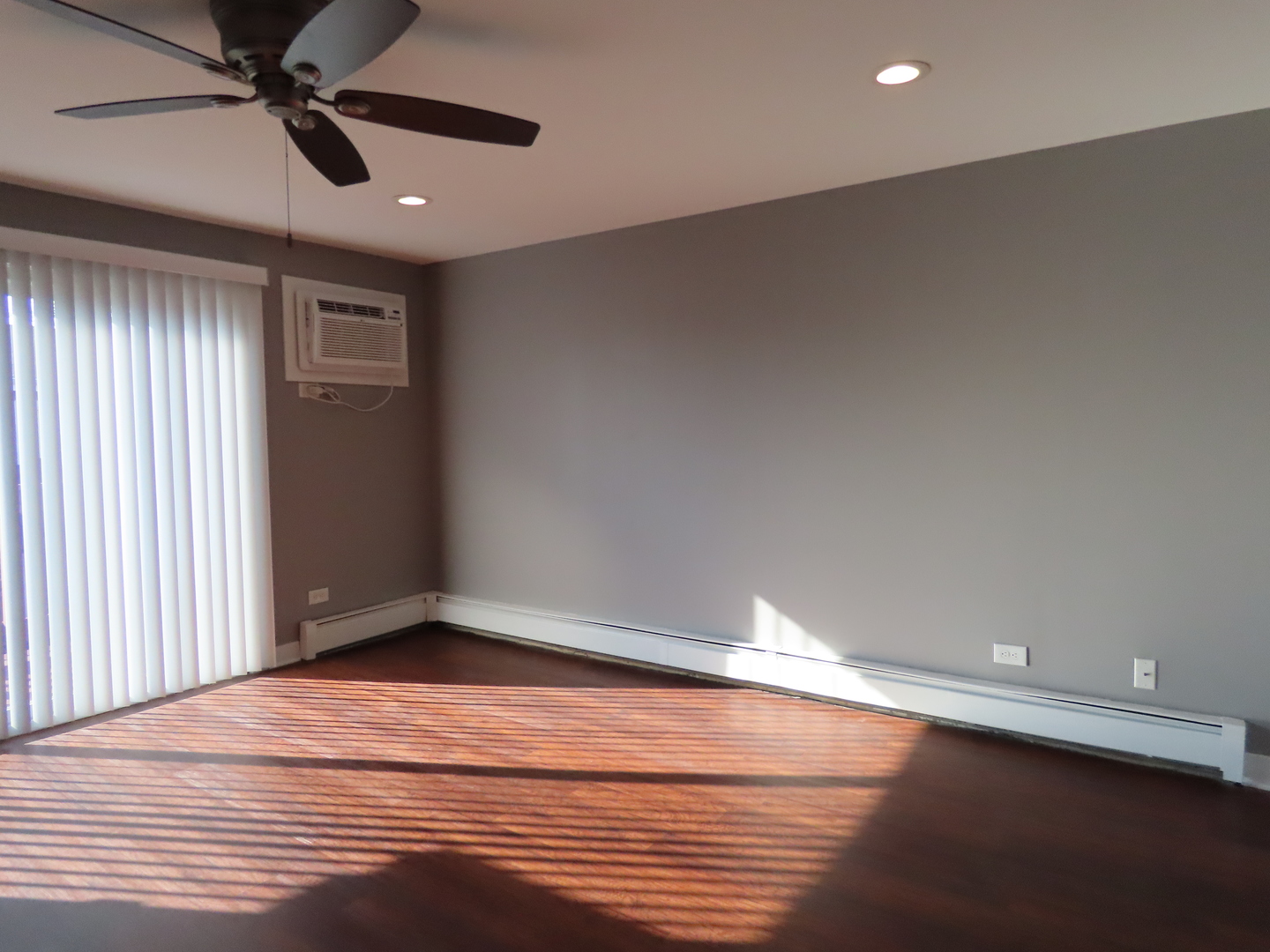 14830 Ketelaar Drive, Unit 4E Midlothian, IL 60445 - Photo 5 of 23 an empty room with wooden floor closet fan and windows