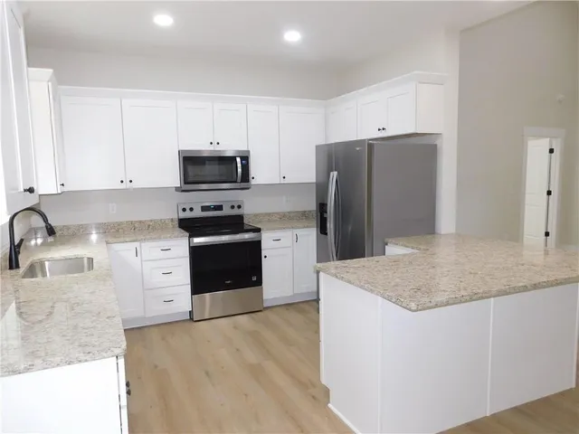 a stove top oven sitting inside of a kitchen