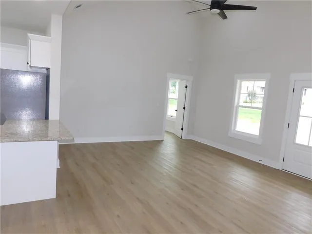 an empty room with windows and closet