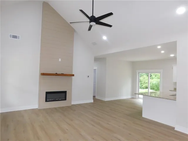 an empty room with windows and a fireplace