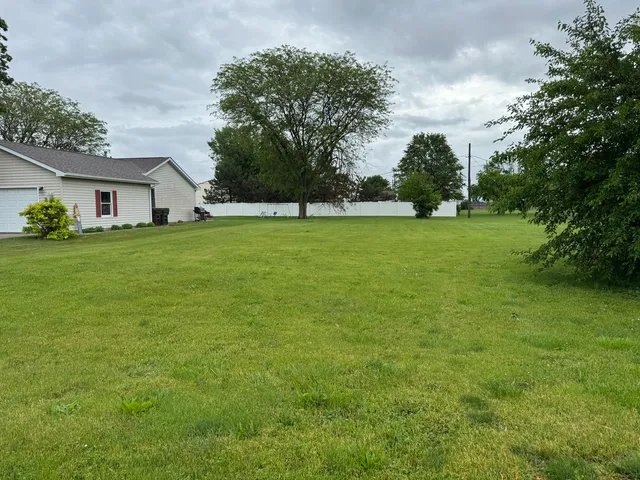 a view of a field of grass and trees