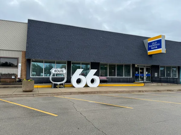 a view of a swimming pool with a lounge chairs in front of building