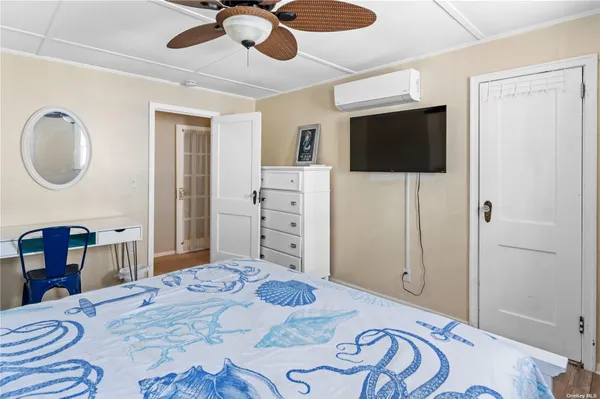 a bedroom with a bed and a flat screen tv