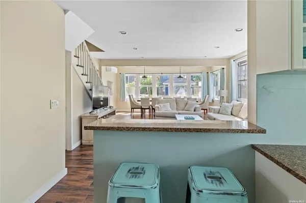 a dining hall with granite countertop a sink and a wooden floor